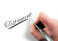 Digitaler Nachlass Eine Hand, die mit einem Stift 'Testament' geschrieben hat.