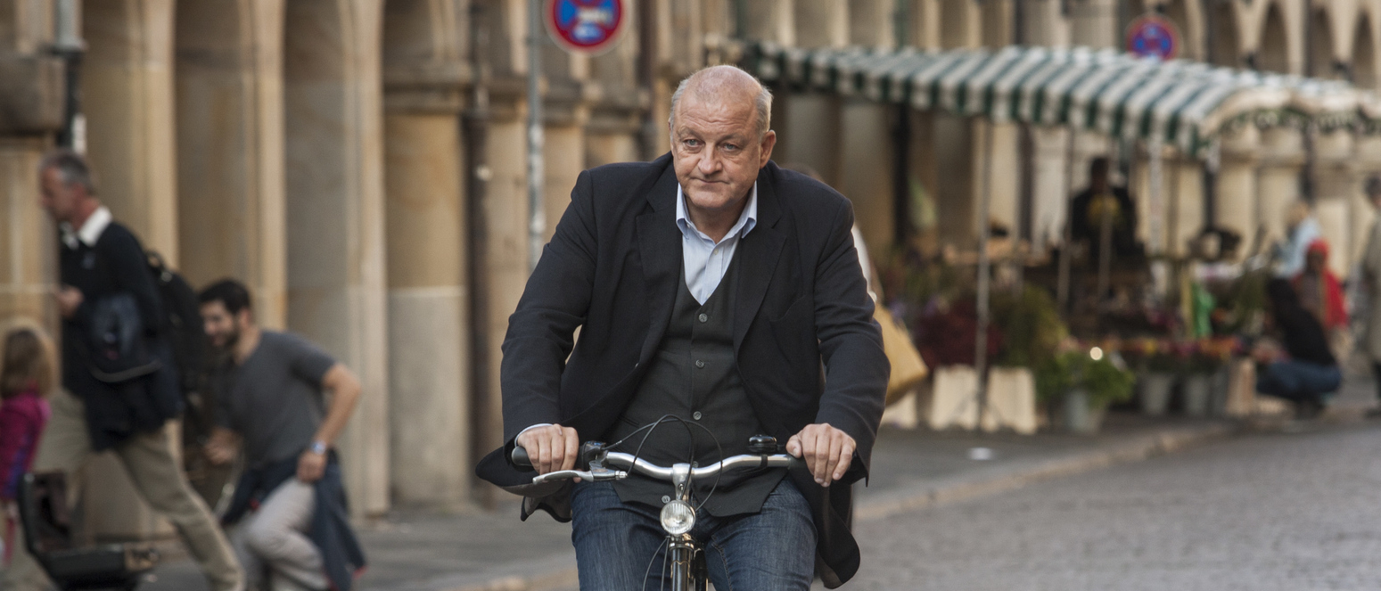 Lansink alias Wilsberg mit dem Fahrrad auf dem Prinzipalmarkt