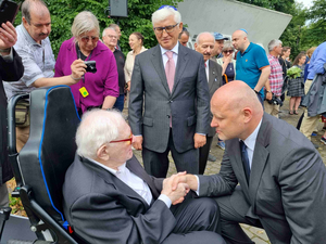 Der lettische Ministerpräsident Andris Kulbergs sucht das Gespräch mit dem 100-jährigen Vestermanis, der im Rollstuhl sitzt