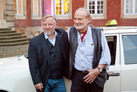 Axel Prahl und Claus C. Clausnitzer vor dem Münster-Tatort-Taxi