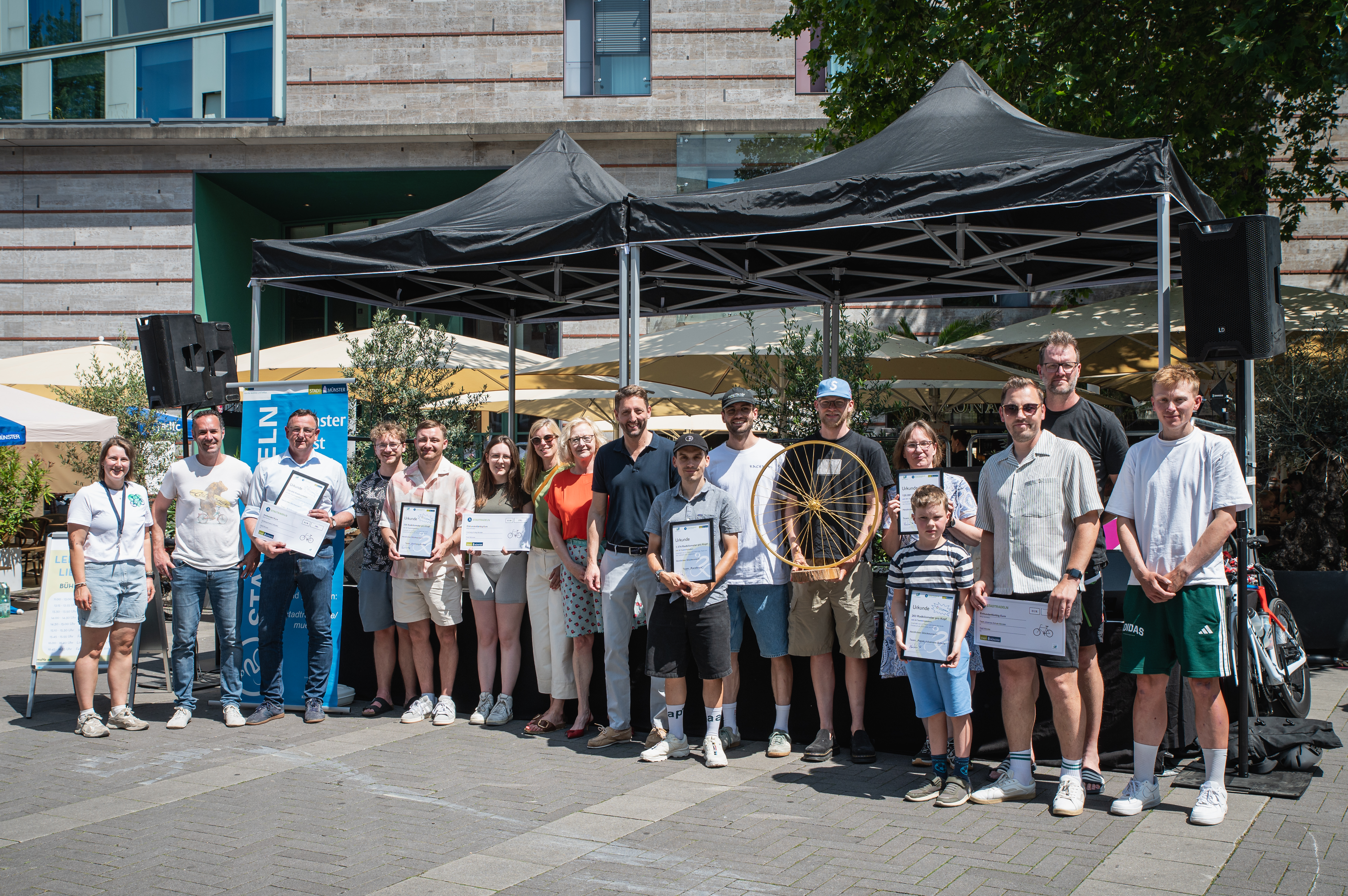 Gruppenfoto mit Vertreterinnen und Vertretern der Stadt Münster sowie Gewinnerinnen und Gewinnern des Stadtradelns mit Urknden in den Händen