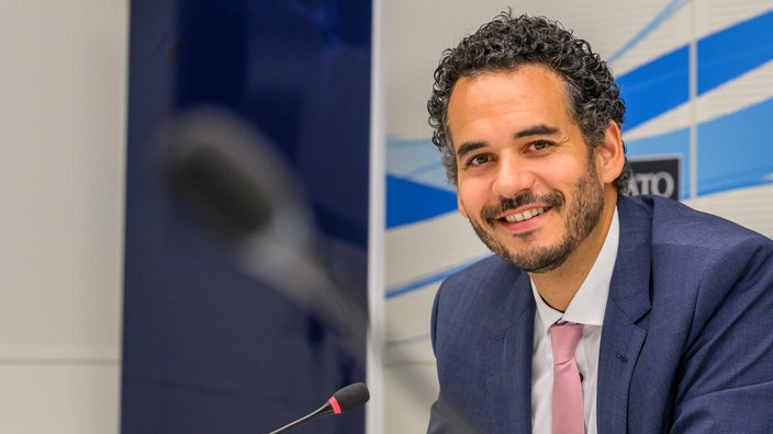 NATO-Referent Dominik Wullers im Anzug bei Konferenz