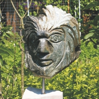 Relief eines Gesichts aus dunkelgrauem Stein