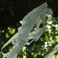 An Quallen erinnernde Objekte aus Glas und Folie in einem Baum schwebend