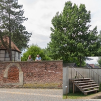 Zwei Personen blicken über die Mauer des Pfründnerhauses