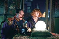 Der Schauspieler Ulli Dietrich als Polizist Dimpfelmoser und die Schauspielerin Christiane Paul als Witwe Schlotterbeck sitzen vor einer leuchtenden weißen Kugel und starren hinein.