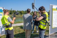 Das Foto zeigt ein Filmteam, das eine Person interviewt.