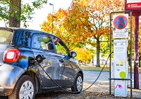 E-Auto wird an einer E-Ladesäuler betankt.