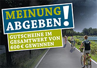 Foto der beleuchteten Kanalpromenade in der Dämmerung, dazu ein Schriftzug 'Meinung abgeben! Gutscheine im Gesamtwert von 600 € gewinnen'