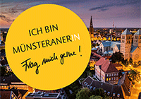 Der Münster-Button Nachtansicht vom Dom, darüber der Münster-Button